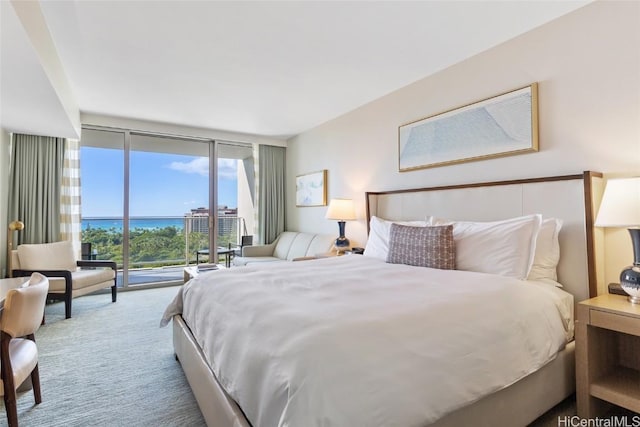 bedroom with access to outside, floor to ceiling windows, and carpet