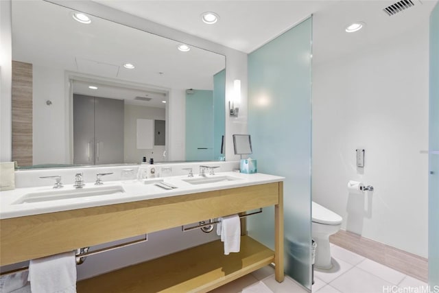 bathroom with tile patterned flooring, vanity, and toilet