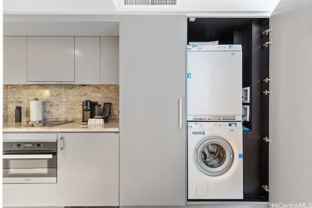 laundry room featuring stacked washer / dryer