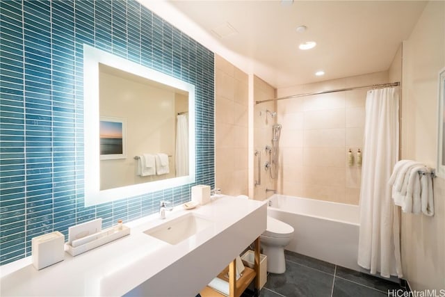 full bathroom featuring sink, tile patterned flooring, tile walls, toilet, and shower / tub combo