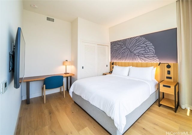 bedroom featuring light hardwood / wood-style floors and a closet