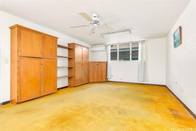 unfurnished bedroom featuring light colored carpet, an AC wall unit, and ceiling fan