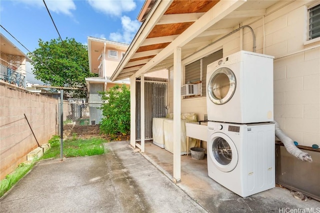 washroom featuring stacked washer / drying machine