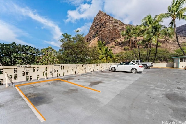 view of vehicle parking featuring a mountain view