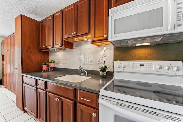 kitchen with sink, backsplash, a textured ceiling, white appliances, and light tile patterned floors