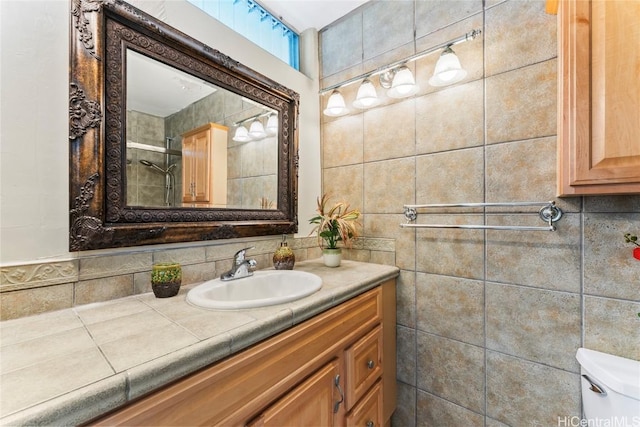 bathroom with tasteful backsplash, vanity, and toilet