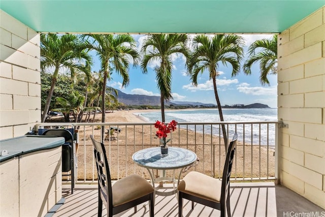 balcony featuring a beach view and a water and mountain view