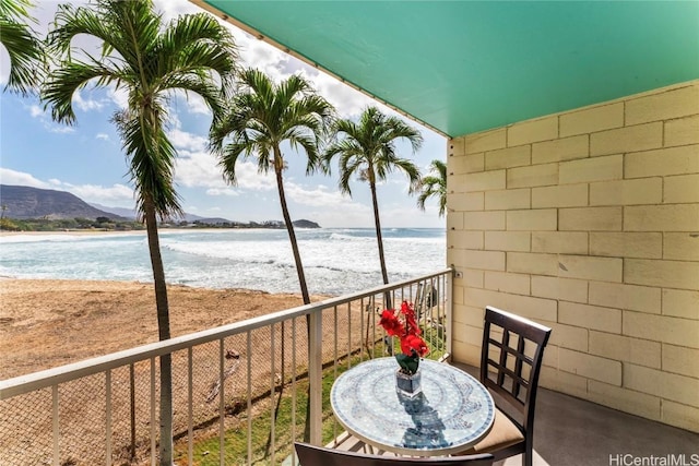 balcony featuring a water and mountain view