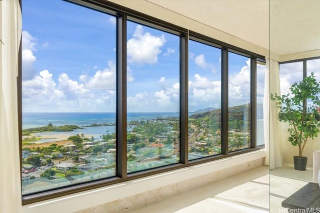 unfurnished sunroom with a water view