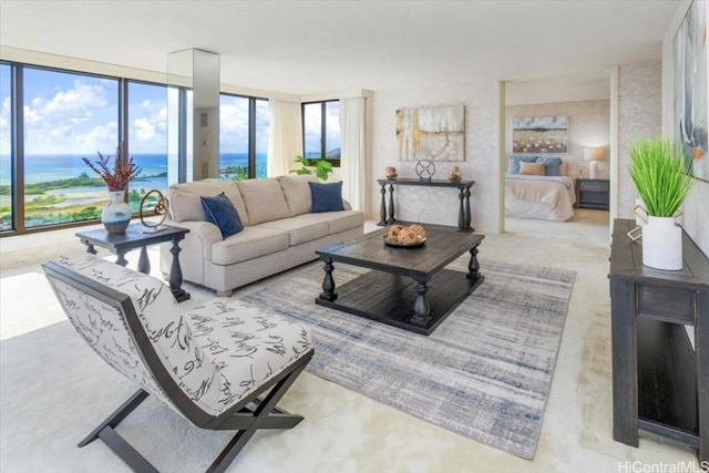 living room featuring a water view and expansive windows