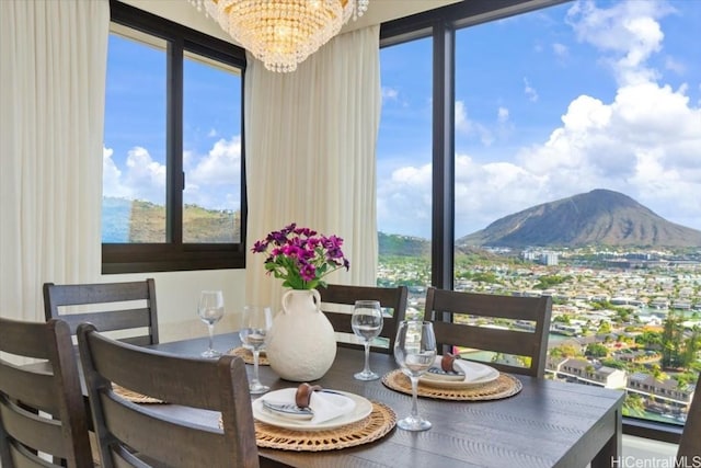 dining room with a mountain view and a chandelier