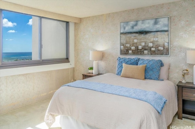 carpeted bedroom featuring a water view