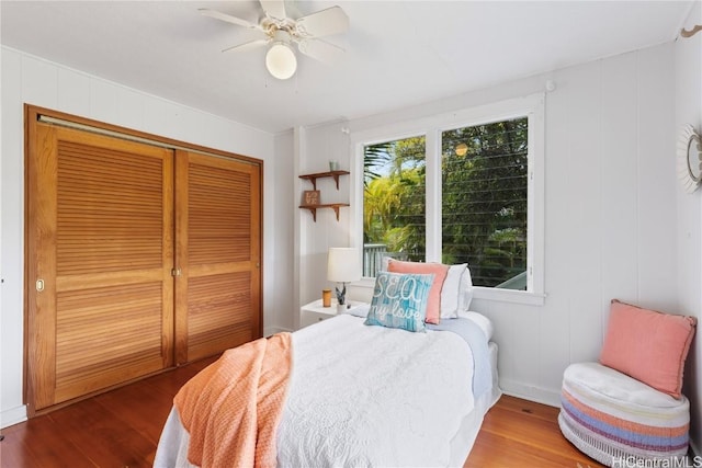 bedroom with ceiling fan, hardwood / wood-style floors, and a closet