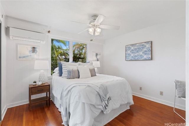 bedroom with ceiling fan, dark hardwood / wood-style floors, and a wall unit AC