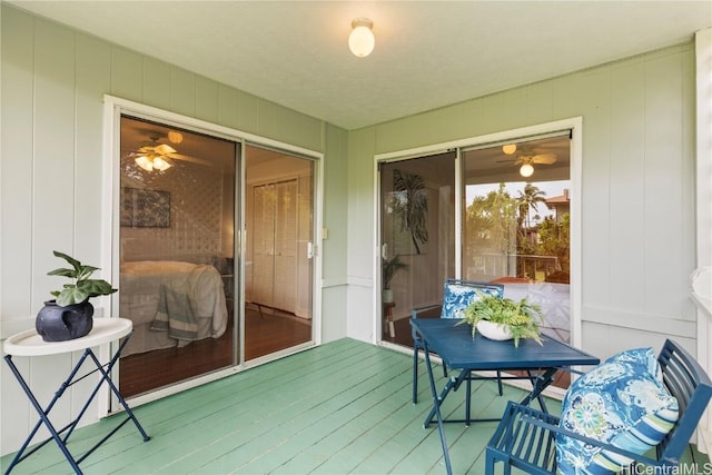 sunroom featuring ceiling fan