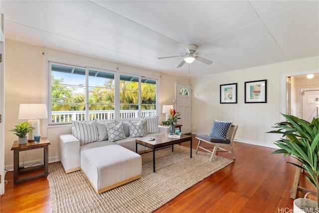 living room featuring light hardwood / wood-style flooring and ceiling fan