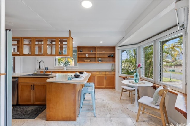 kitchen featuring sink, a breakfast bar area, and stainless steel dishwasher