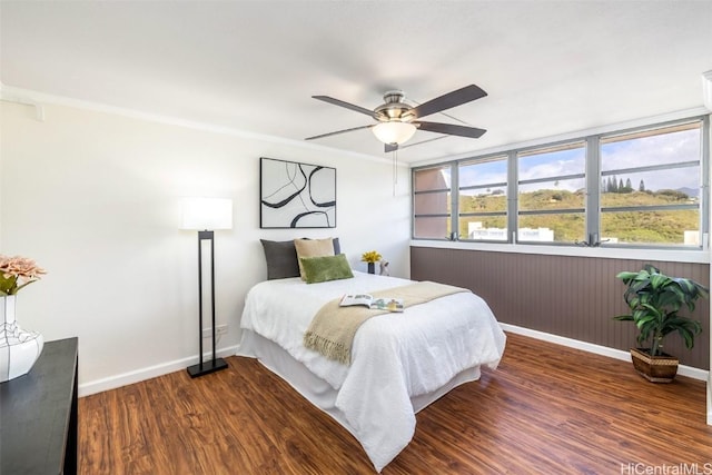 bedroom featuring ceiling fan, crown molding, and dark hardwood / wood-style floors