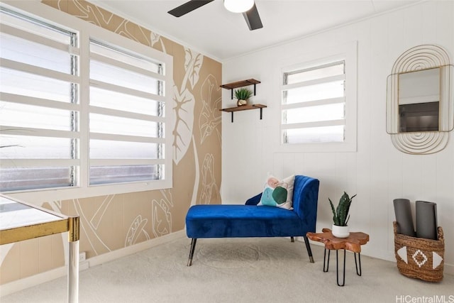 living area featuring crown molding, carpet, and a healthy amount of sunlight