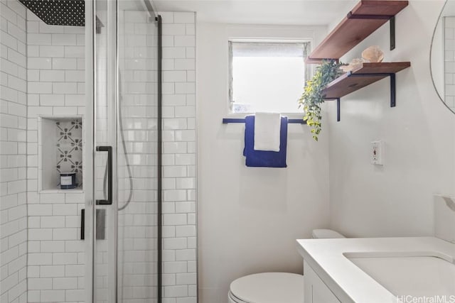 bathroom with vanity, an enclosed shower, and toilet