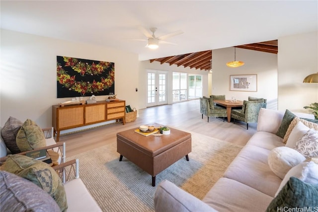 living room with french doors, vaulted ceiling with beams, light hardwood / wood-style floors, and ceiling fan