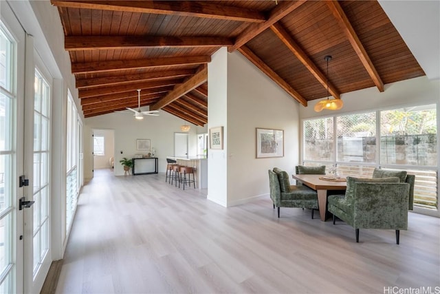 unfurnished sunroom featuring vaulted ceiling with beams, ceiling fan, wood ceiling, and french doors