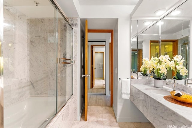 bathroom with combined bath / shower with glass door and sink