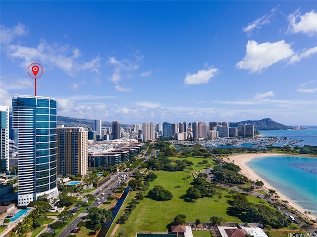 bird's eye view featuring a view of the beach, a city view, and a water view