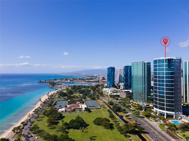 birds eye view of property with a view of city, a view of the beach, and a water view