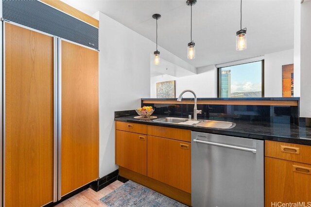 kitchen with stainless steel dishwasher, decorative light fixtures, paneled fridge, and sink