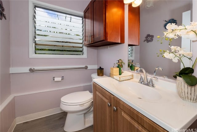 bathroom featuring hardwood / wood-style flooring, vanity, and toilet