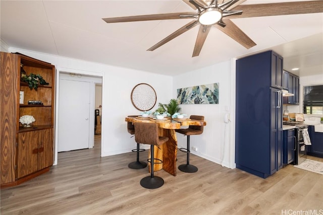 dining area featuring light wood-type flooring and ceiling fan