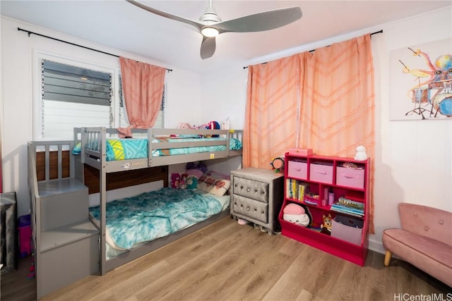 bedroom with ceiling fan and wood-type flooring