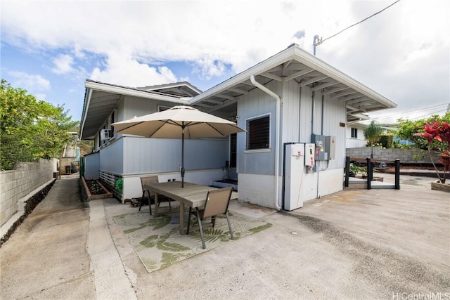 view of side of home with a patio