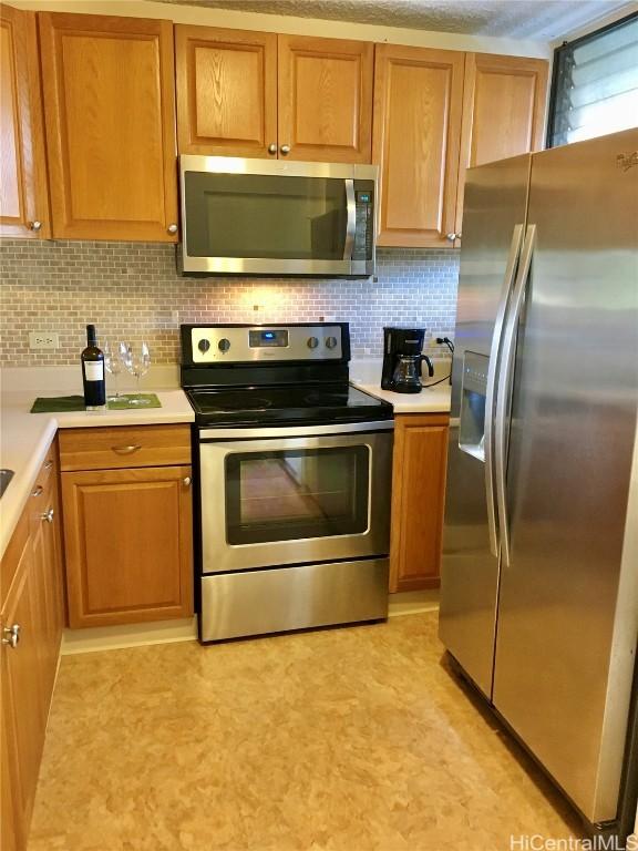 kitchen featuring appliances with stainless steel finishes and decorative backsplash