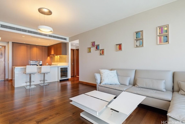 living room with dark wood-type flooring and beverage cooler