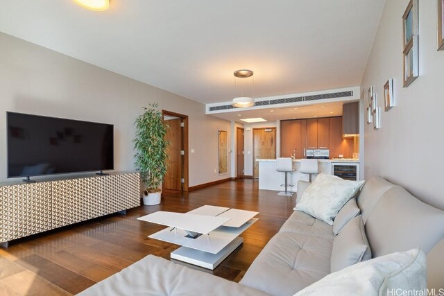 living room with wine cooler and dark hardwood / wood-style floors