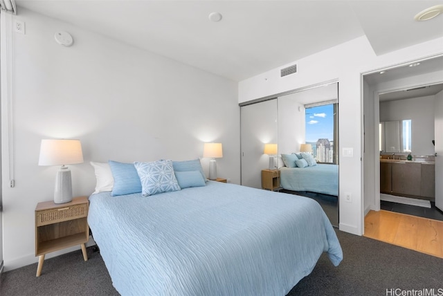 bedroom with carpet and a closet