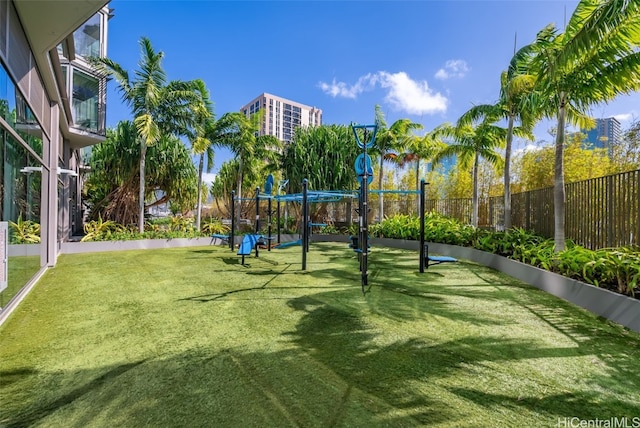 view of property's community with a playground and a lawn