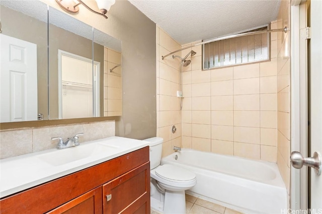 full bathroom featuring decorative backsplash, vanity, a textured ceiling, toilet, and tiled shower / bath