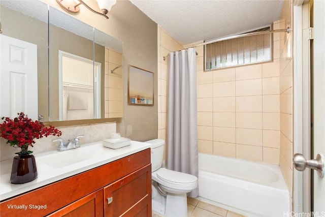 full bathroom featuring tile patterned floors, shower / bath combination with curtain, a textured ceiling, toilet, and vanity