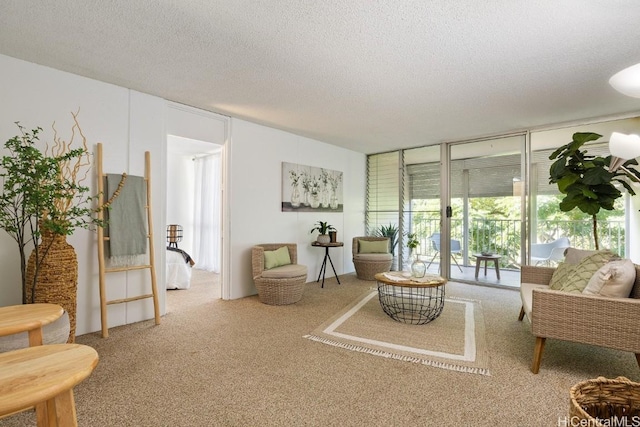 living room featuring carpet, a wall of windows, and a textured ceiling