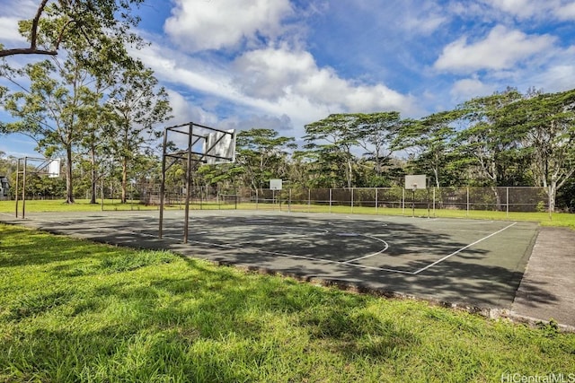 view of sport court with a lawn