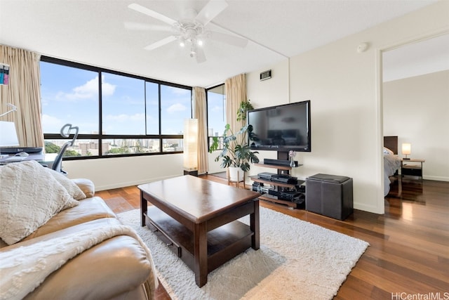 living room with hardwood / wood-style floors and ceiling fan