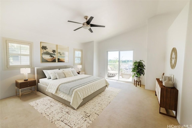 carpeted bedroom featuring access to exterior, vaulted ceiling, and ceiling fan