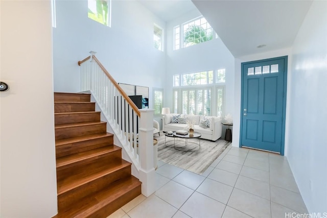 tiled foyer entrance featuring a high ceiling