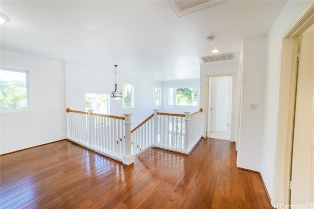 hall featuring crown molding and wood-type flooring