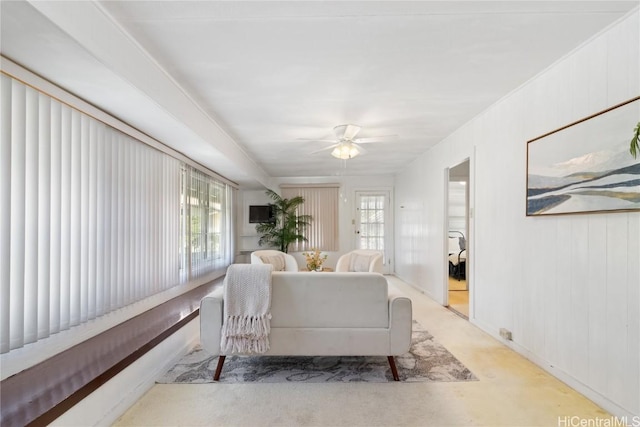 living room with light colored carpet and ceiling fan