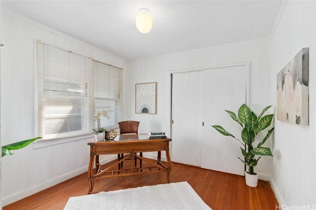 home office with hardwood / wood-style floors and crown molding