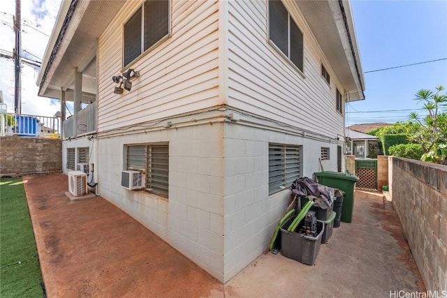 view of side of home featuring ac unit, cooling unit, and a patio